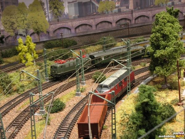 Während die 220 gerade ausfährt, hat die 141 mit ihrer Regionalbahn die Rampe so gut wie hinter sich gebracht und fährt gleich in den Bahnhof ein.