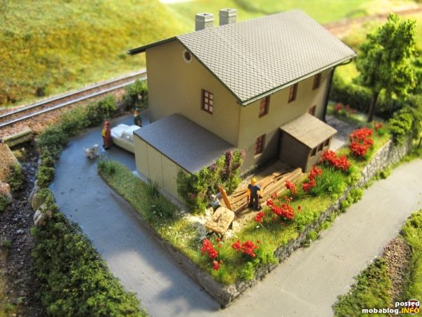 Der Blick von der anderen Seite: im Vorgarten wird fleißig gearbeitet - alte Bretter sind mit einer Kreissäge zu Brennholz zu schneiden...