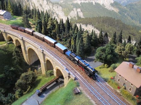 Ein Blick vom Waldrand oberhalb des Höllgrabens zeigt eine 52er mit einem Güterzug